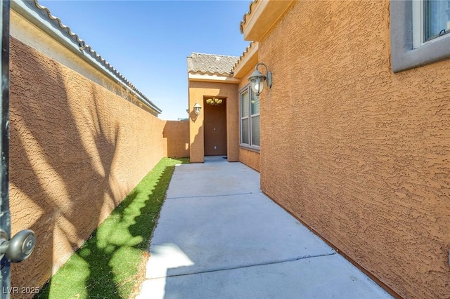 view of home's exterior featuring stucco siding, a patio area, and a fenced backyard