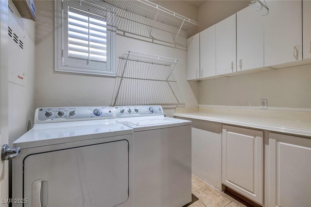 washroom featuring cabinet space and washing machine and dryer