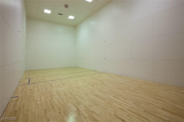 view of home's community featuring a sport court