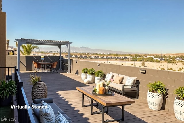 wooden terrace with outdoor lounge area, a mountain view, and outdoor dining space