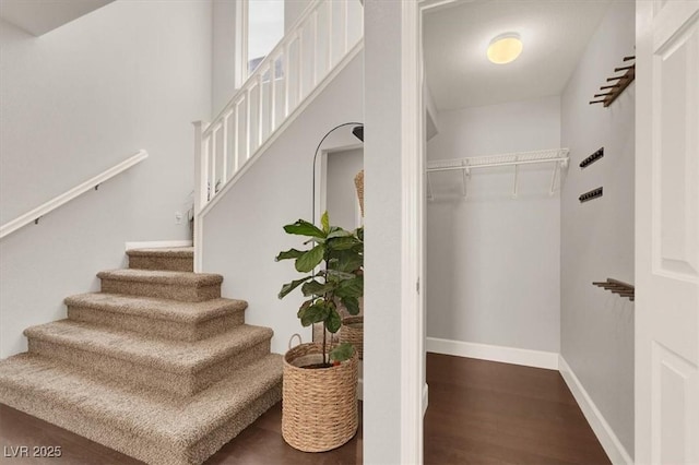 stairs with wood finished floors and baseboards