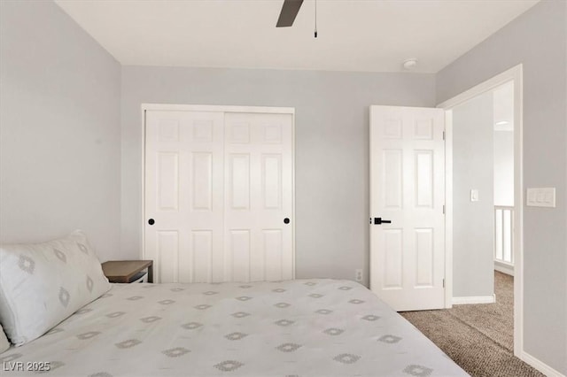 unfurnished bedroom featuring carpet flooring, a closet, ceiling fan, and baseboards