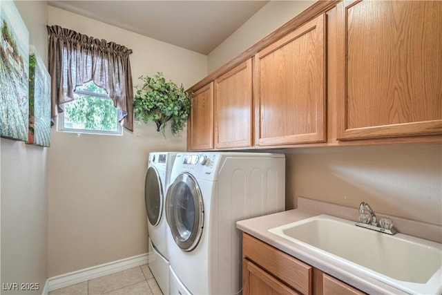 4419 Via Bianca Ave, Las Vegas, NV 89141 - laundry area with cabinet space, washing machine and clothes dryer, baseboards, and light tile patterned flooring