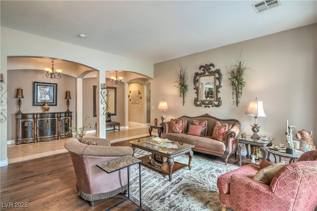 4419 Via Bianca Ave, Las Vegas, NV 89141 - living area featuring arched walkways, dark wood-type flooring, a chandelier, and baseboards