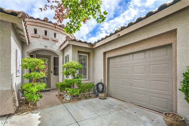 4419 Via Bianca Ave, Las Vegas, NV 89141 - doorway to property with stucco siding, concrete driveway, a garage, and a tile roof