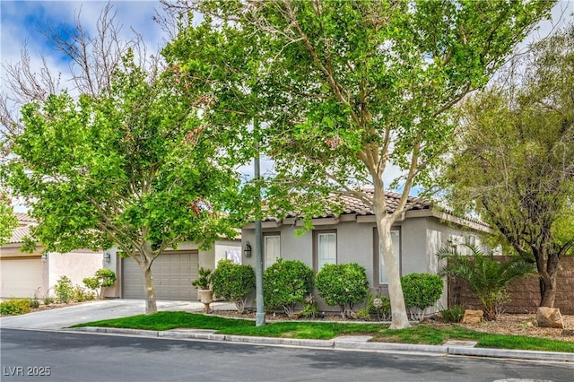 4419 Via Bianca Ave, Las Vegas, NV 89141 - view of property hidden behind natural elements with stucco siding and driveway