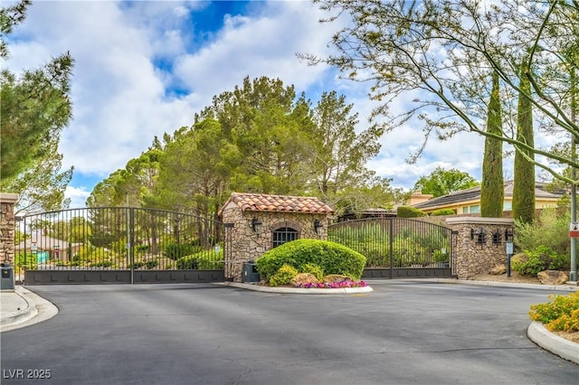 4419 Via Bianca Ave, Las Vegas, NV 89141 - view of asphalt road featuring a gate, a gated entry, and curbs
