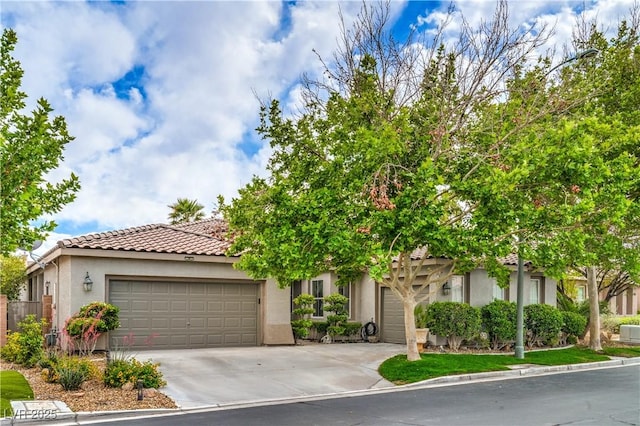4419 Via Bianca Ave, Las Vegas, NV 89141 - view of front facade with an attached garage, stucco siding, a tiled roof, and driveway