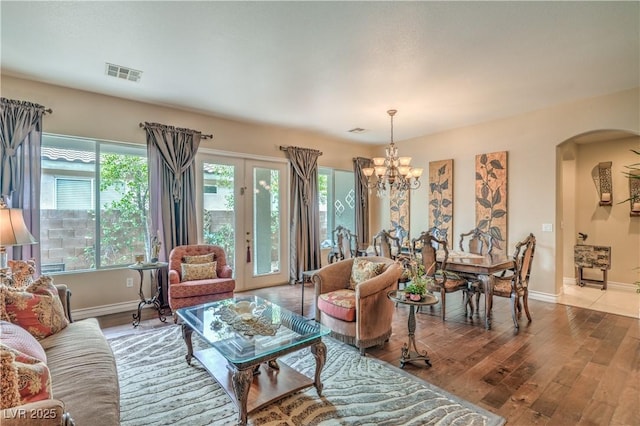 4419 Via Bianca Ave, Las Vegas, NV 89141 - living area with arched walkways, plenty of natural light, a chandelier, and wood finished floors