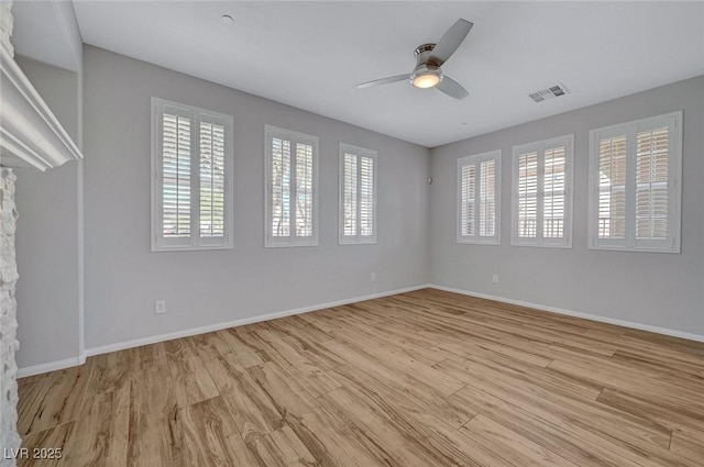 unfurnished living room with wood finished floors, ceiling fan, and baseboards