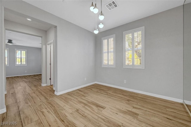 unfurnished dining area with baseboards, light wood-style flooring, and ceiling fan