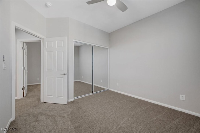 unfurnished bedroom with carpet, baseboards, a closet, and ceiling fan