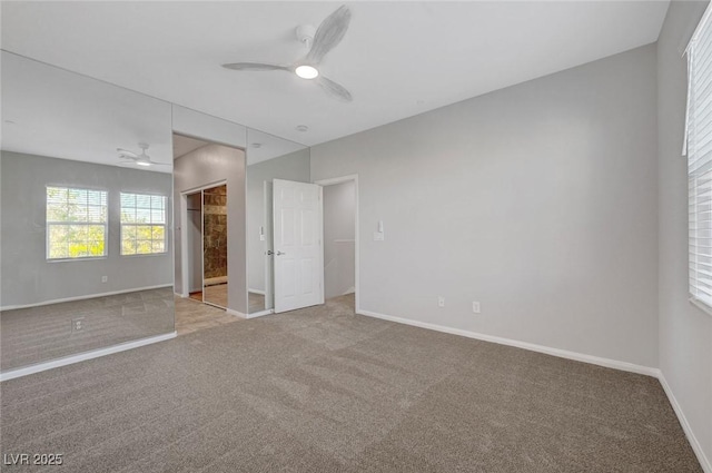 unfurnished bedroom featuring carpet floors, baseboards, and a ceiling fan