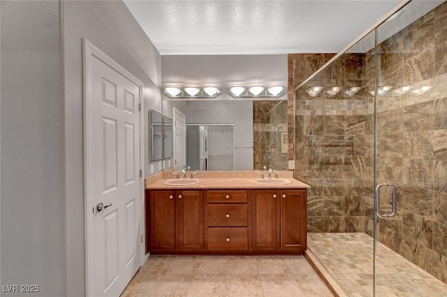 full bathroom featuring a shower stall and double vanity
