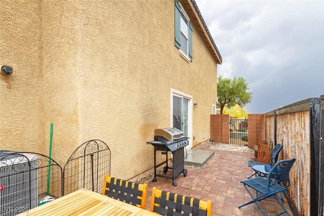 9925 Turquoise Glass Ct, Las Vegas, NV 89178 - view of patio with area for grilling and a fenced backyard