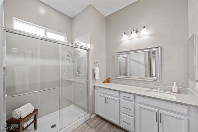 full bathroom with a stall shower and vanity