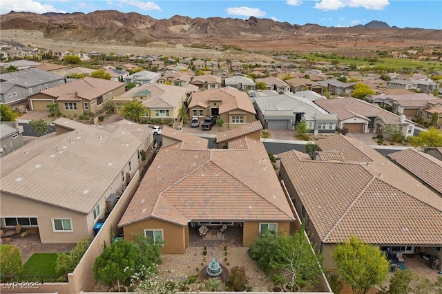 aerial view of residential area featuring a mountainous background