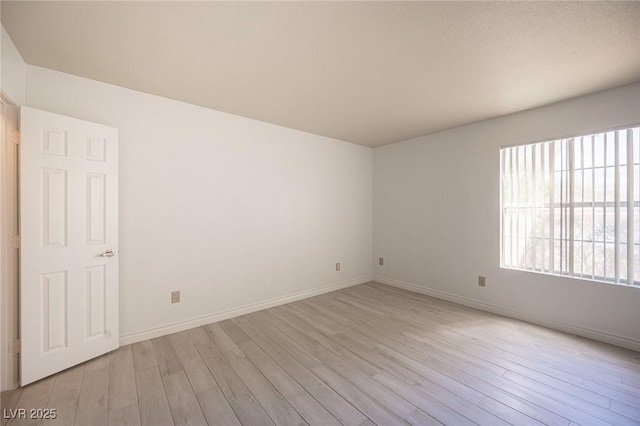 2606 S Durango Dr Unit 122, Las Vegas, NV 89117 - unfurnished room with light wood-style floors and baseboards