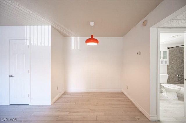 2606 S Durango Dr Unit 122, Las Vegas, NV 89117 - unfurnished dining area with light wood-style floors and baseboards