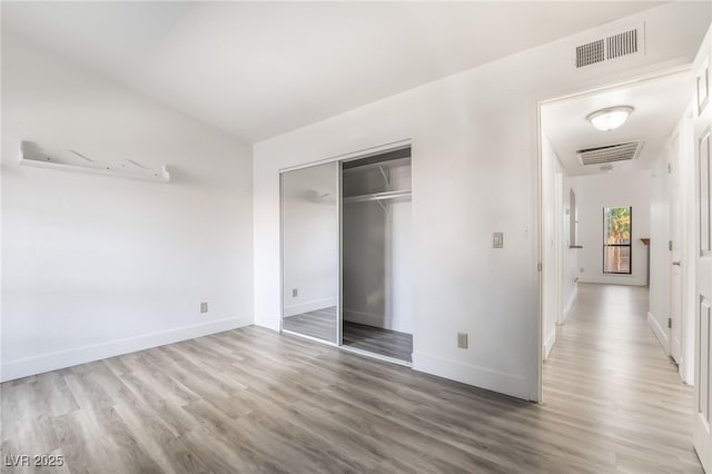 611 Bass Dr Unit C, Henderson, NV 89014 - unfurnished bedroom featuring wood finished floors, baseboards, and a closet
