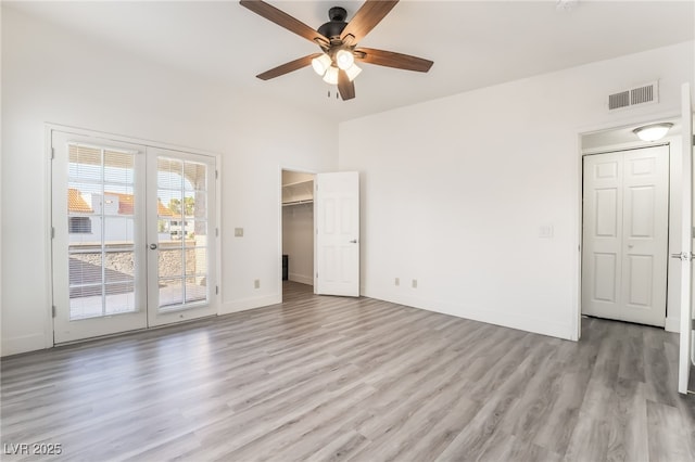 611 Bass Dr Unit C, Henderson, NV 89014 - unfurnished bedroom with access to outside, light wood-type flooring, baseboards, ceiling fan, and a walk in closet