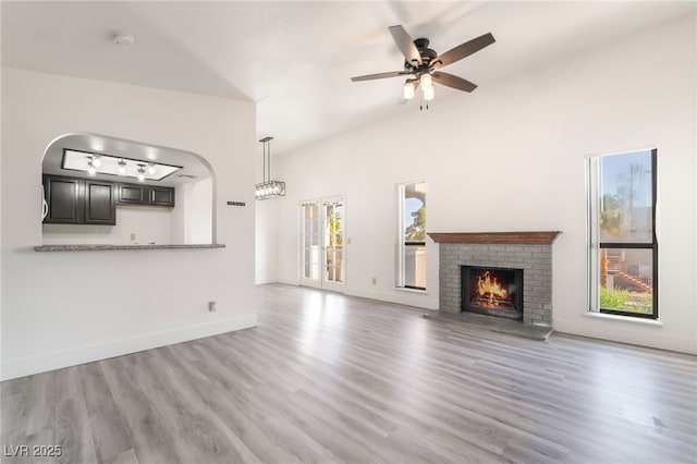 611 Bass Dr Unit C, Henderson, NV 89014 - unfurnished living room with wood finished floors, a brick fireplace, ceiling fan, and baseboards