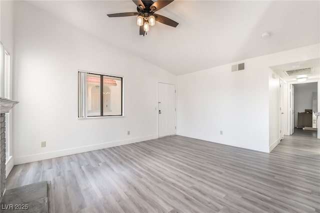611 Bass Dr Unit C, Henderson, NV 89014 - unfurnished living room with lofted ceiling, a ceiling fan, wood finished floors, baseboards, and a fireplace