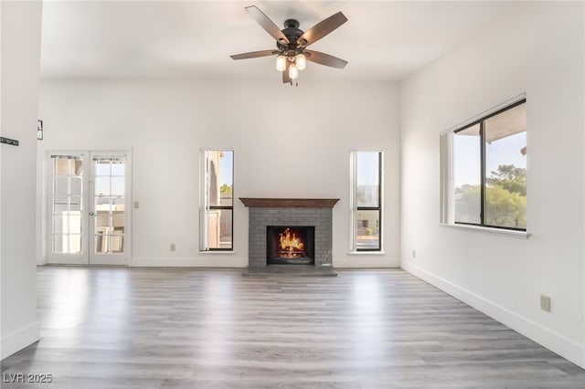 611 Bass Dr Unit C, Henderson, NV 89014 - unfurnished living room with healthy amount of natural light, a ceiling fan, and wood finished floors