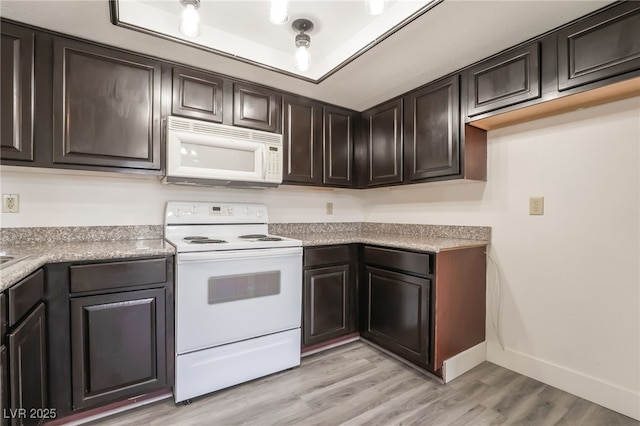 611 Bass Dr Unit C, Henderson, NV 89014 - kitchen with white appliances, light wood finished floors, baseboards, dark brown cabinets, and light countertops