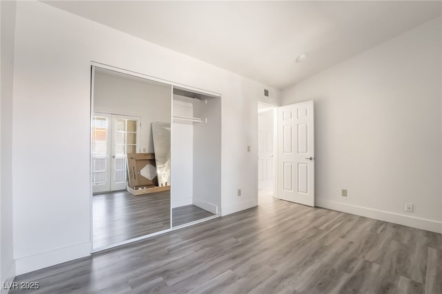 611 Bass Dr Unit C, Henderson, NV 89014 - unfurnished bedroom with wood finished floors, baseboards, and a closet