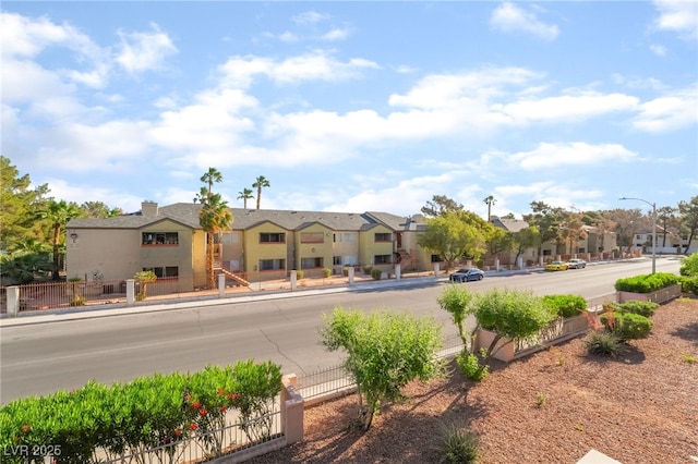 611 Bass Dr Unit C, Henderson, NV 89014 - view of front facade featuring a residential view, fence, and stucco siding