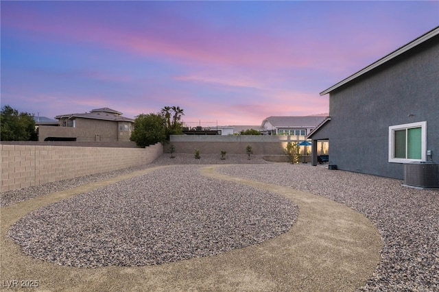 5449 Hickory Tree St, Las Vegas, NV 89149 - yard at dusk featuring a fenced backyard and central AC unit