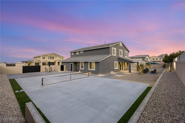 5449 Hickory Tree St, Las Vegas, NV 89149 - back of property with a fenced backyard, stucco siding, a tennis court, and a patio area