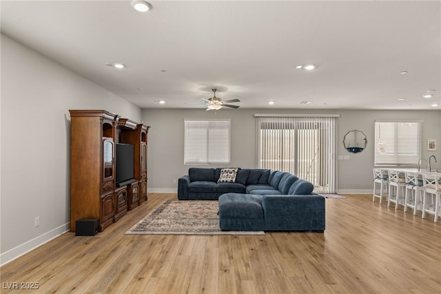 5449 Hickory Tree St, Las Vegas, NV 89149 - living room featuring light wood-type flooring, baseboards, ceiling fan, and recessed lighting