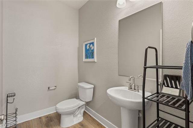 5449 Hickory Tree St, Las Vegas, NV 89149 - bathroom with wood finished floors, baseboards, and toilet