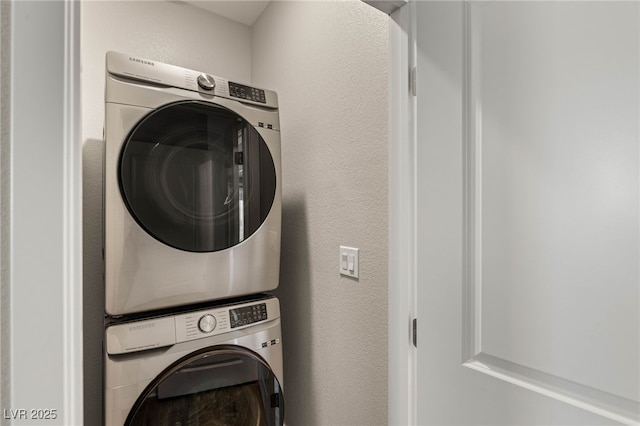 5449 Hickory Tree St, Las Vegas, NV 89149 - clothes washing area featuring stacked washer / dryer and a textured wall