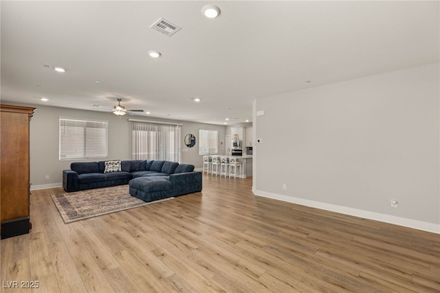 5449 Hickory Tree St, Las Vegas, NV 89149 - living area with a ceiling fan, light wood-style flooring, recessed lighting, and baseboards