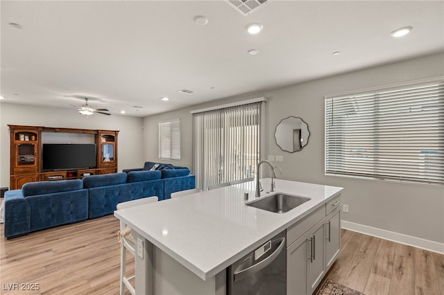 5449 Hickory Tree St, Las Vegas, NV 89149 - kitchen with a sink, dishwasher, light countertops, light wood finished floors, and ceiling fan