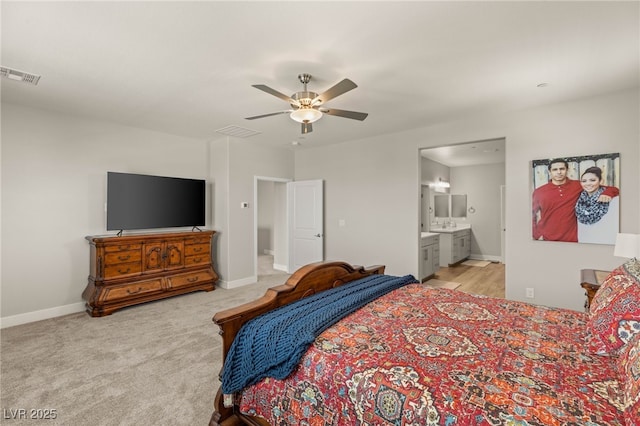 5449 Hickory Tree St, Las Vegas, NV 89149 - bedroom with light colored carpet, connected bathroom, baseboards, and ceiling fan