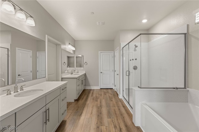 5449 Hickory Tree St, Las Vegas, NV 89149 - full bath with a stall shower, wood finished floors, two vanities, and a garden tub
