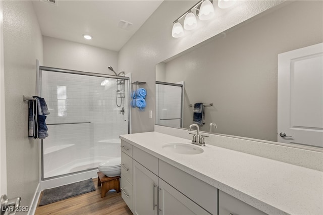 5449 Hickory Tree St, Las Vegas, NV 89149 - full bath featuring a stall shower, wood finished floors, vanity, and toilet