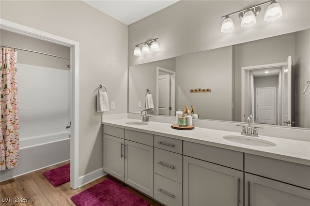 5449 Hickory Tree St, Las Vegas, NV 89149 - bathroom with wood finished floors, double vanity, and shower / bathtub combination with curtain
