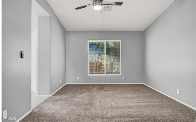 carpeted empty room with ceiling fan and baseboards