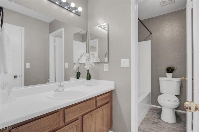 full bathroom featuring vanity, shower / bathtub combination, toilet, and a textured wall