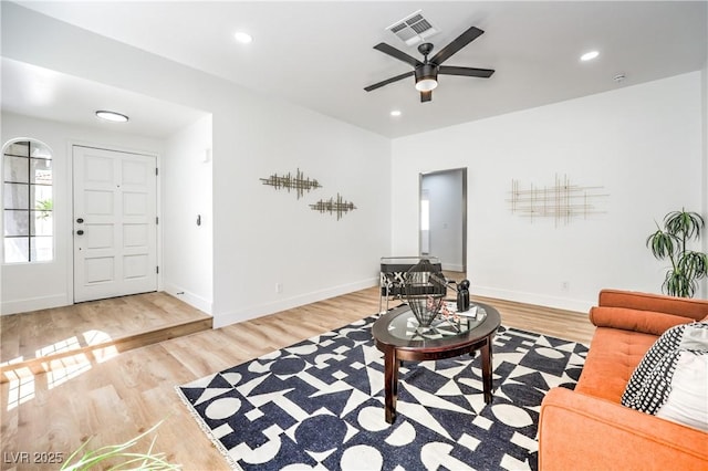 living area featuring ceiling fan, wood finished floors, baseboards, and recessed lighting