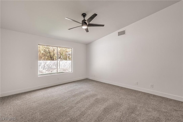 carpeted empty room featuring a ceiling fan, baseboards, and vaulted ceiling