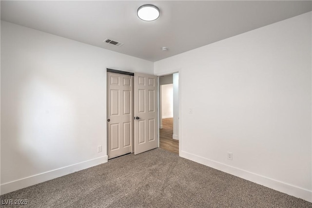 unfurnished bedroom with baseboards and carpet