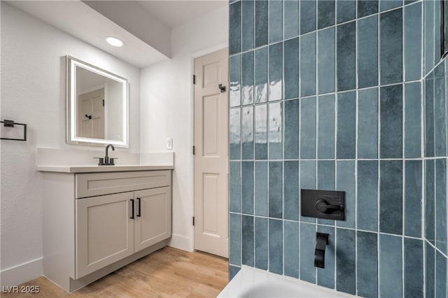 bathroom featuring vanity, wood finished floors, a shower, a tub, and recessed lighting