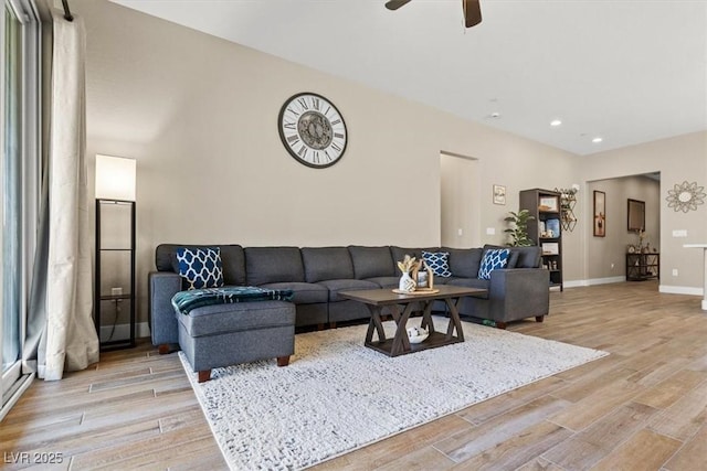 living room featuring light wood finished floors, ceiling fan, recessed lighting, and baseboards