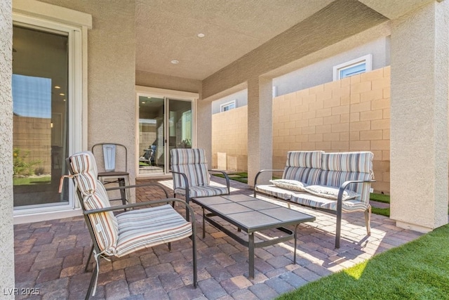 view of patio / terrace with an outdoor living space and fence